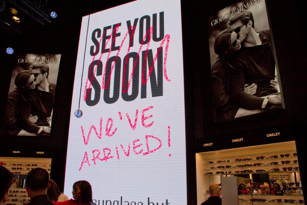 Large-format digital display inside an optical retail store featuring branded visual communications and experiential signage by Gable.