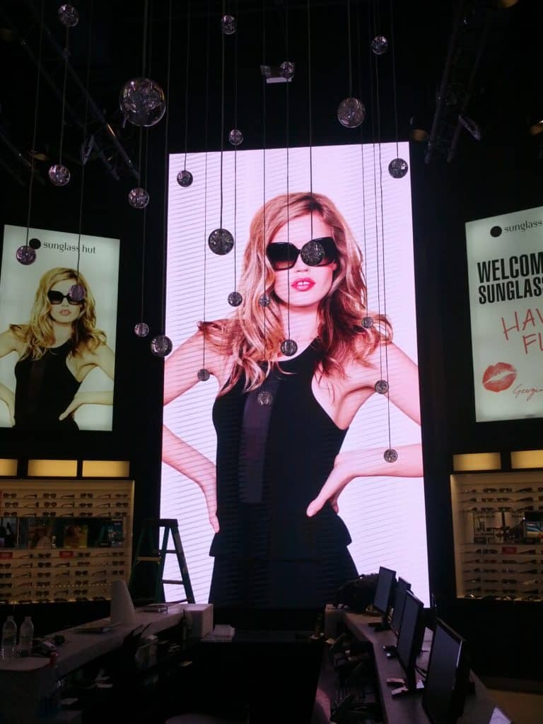 Portrait-style LED retail display showcasing fashion eyewear advertising and digital signage by Gable.