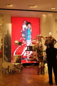 Macy's LED display behind mannequin showcase