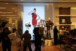 Macy's LED display behind mannequin showcase