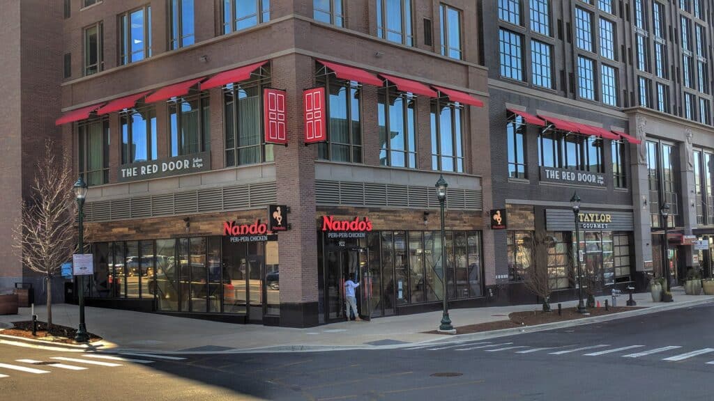 The Red Door Salon & Spa corner storefront featuring large-scale architectural signage and urban retail branding by Gable.