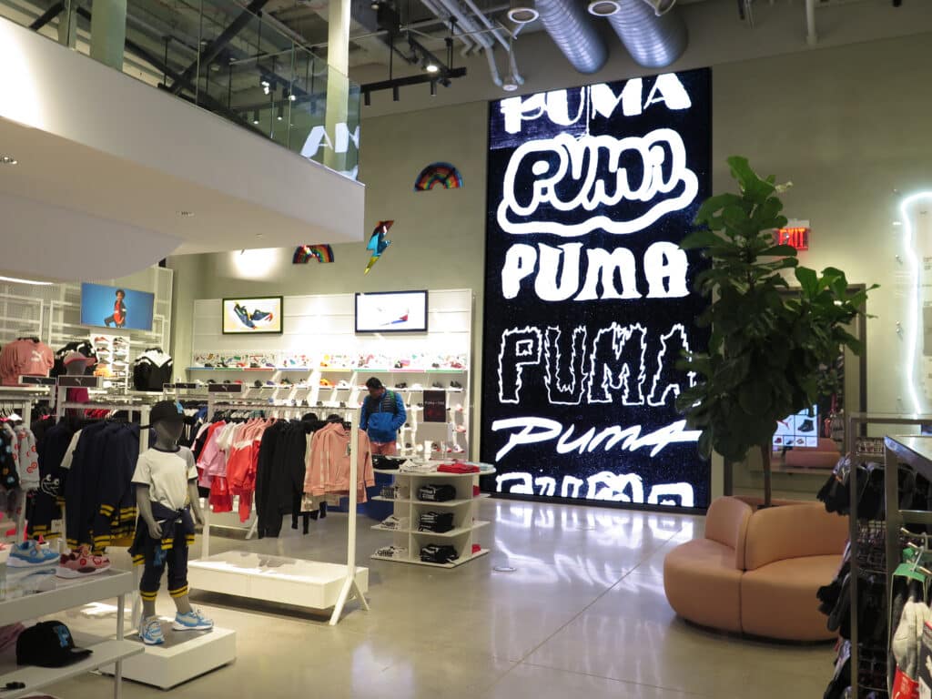 Puma retail store interior with large-format digital branding wall and experiential visual communications by Gable.