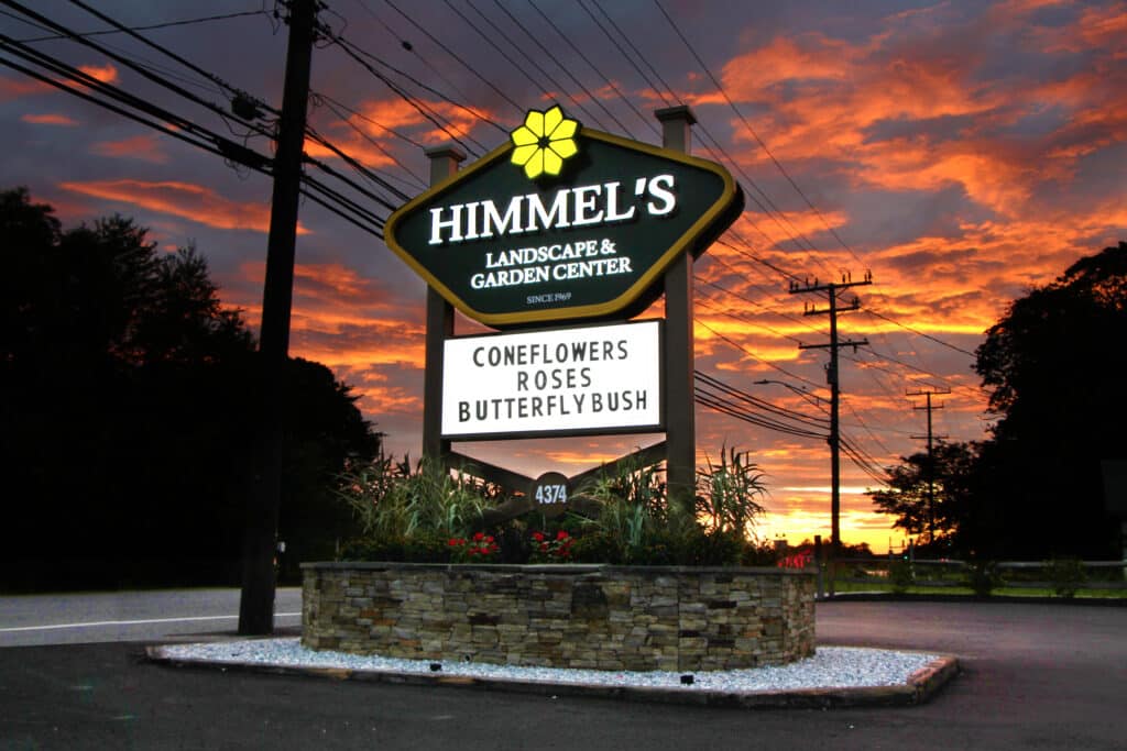 Illuminated Himmel’s Landscape & Garden Center roadside sign at sunset featuring custom retail signage by Gable.