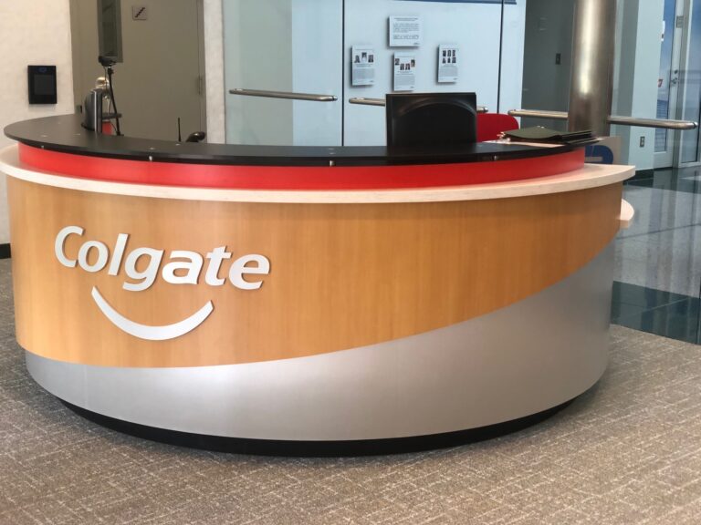 Colgate impact logo on receptionist desk