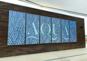 Aqua aluminum sign with routed pattern and copy on acrylic containing color-changing LEDs at Choctaw Casino & Resort