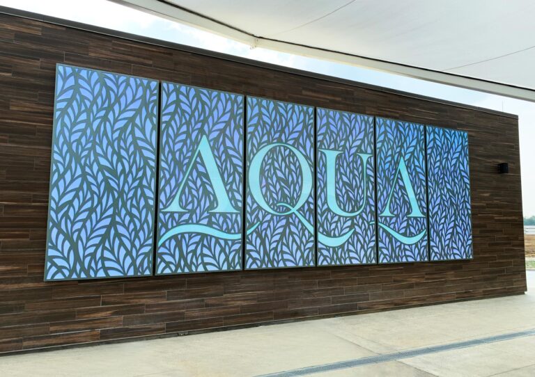 Aqua aluminum sign with routed pattern and copy on acrylic containing color-changing LEDs at Choctaw Casino & Resort