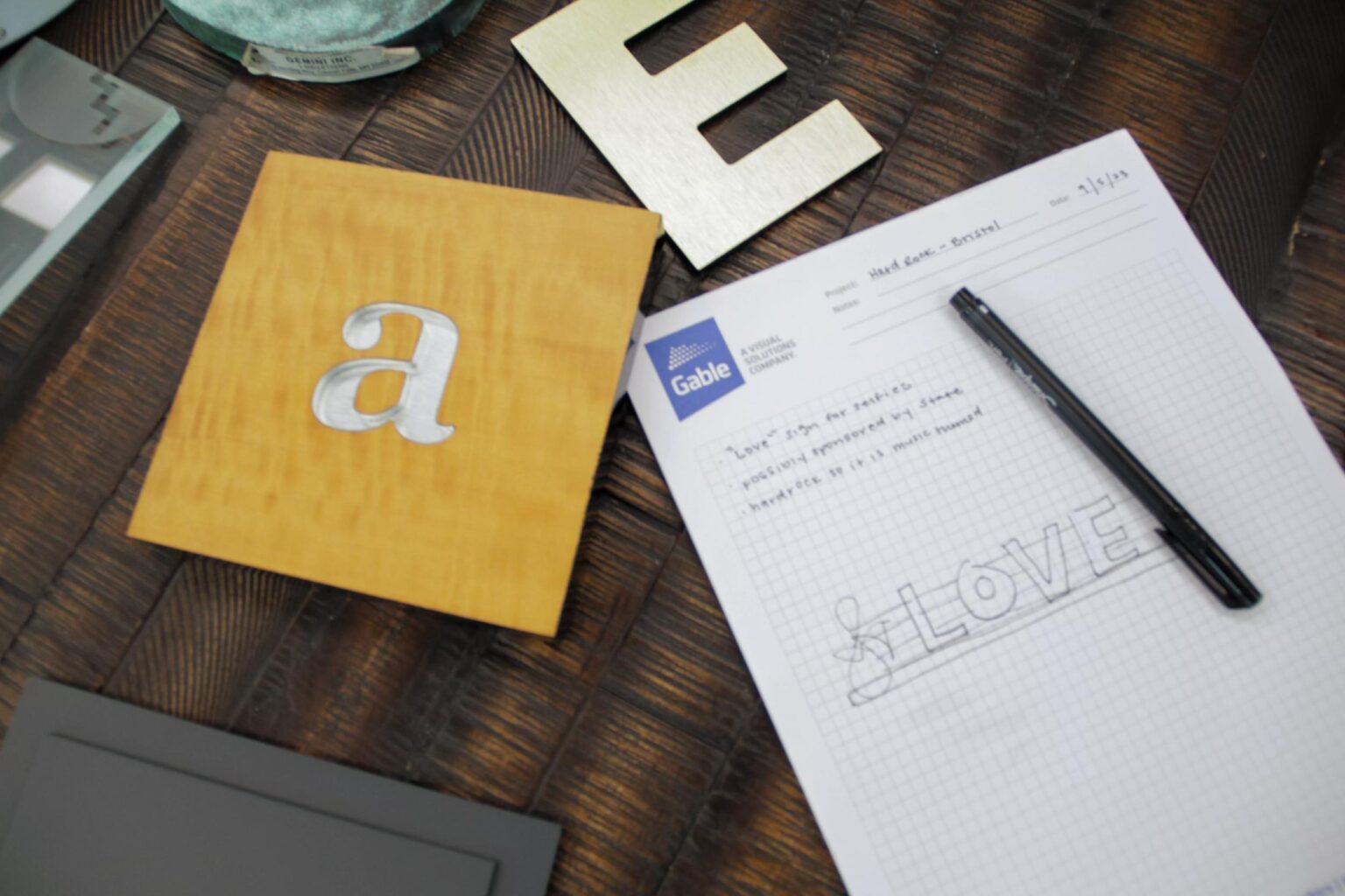 Sample letters with a note pad on a table