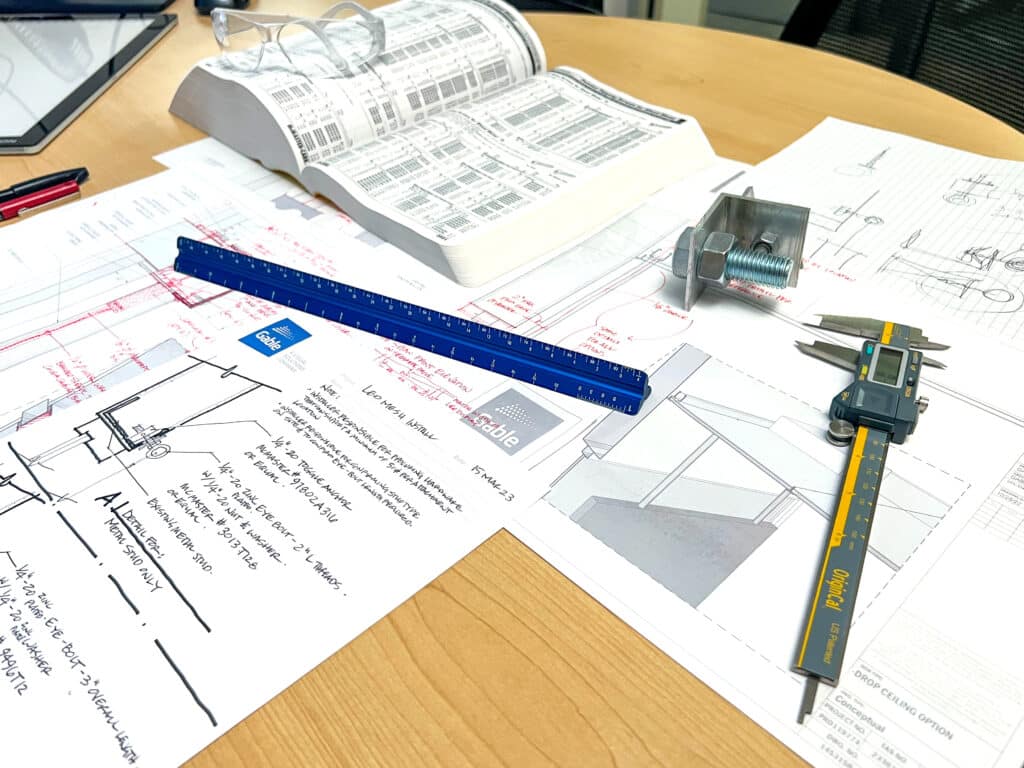 Measurement tools being used to create attachment methods for a technical design.
