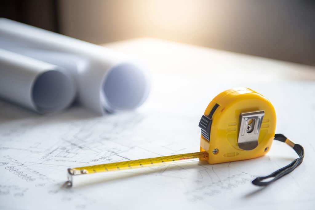 Architectural technical surveys and yellow tape measure, Architecture and building construction industry concepts