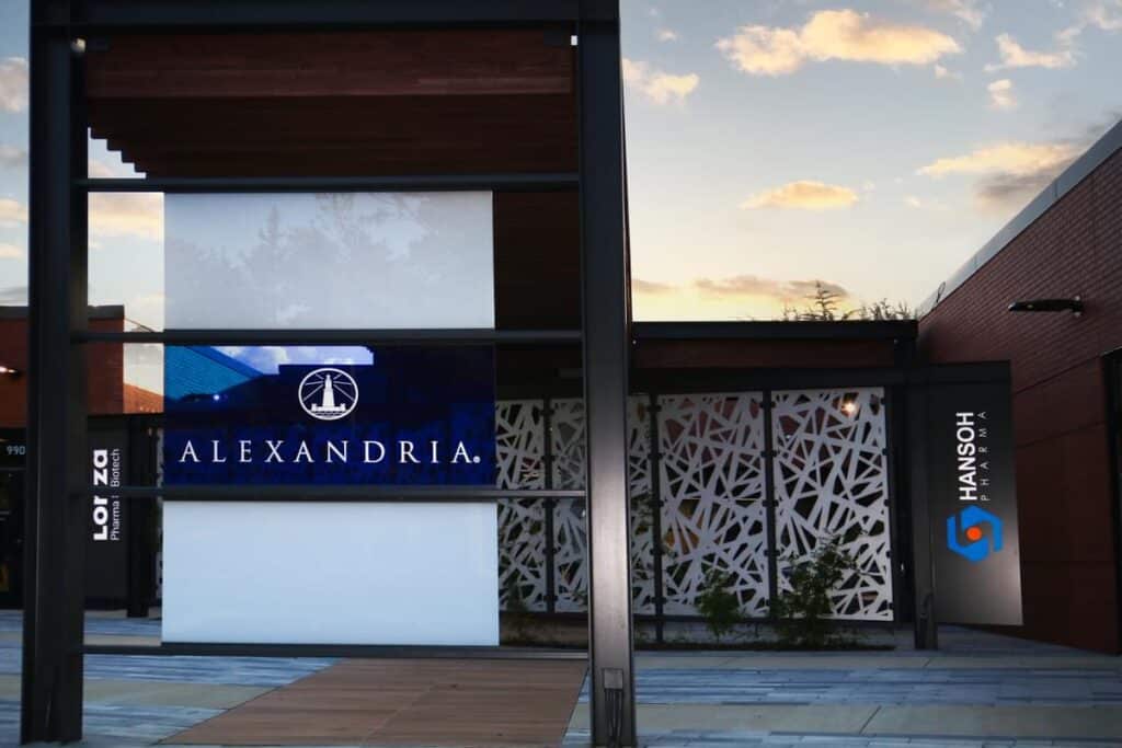 Alexandria building entrance with illuminated tenant branding and custom exterior graphics by Gable.