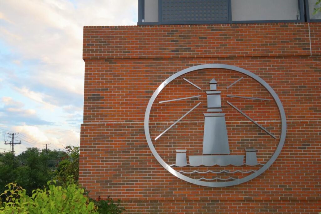 Alexandria Center for Life Science exterior emblem mounted on brick facade with architectural branding by Gable.