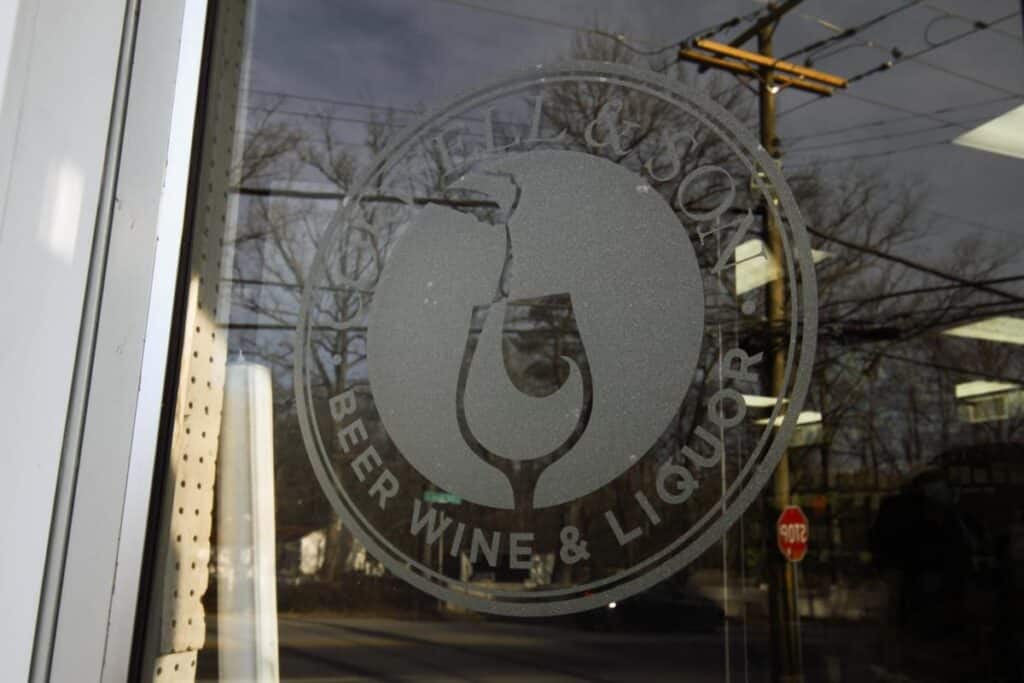 Corwell’s window logo decal showcasing branded retail graphics and storefront detailing by Gable.