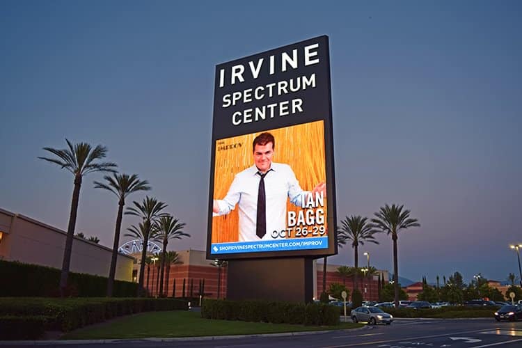 Irvine Spectrum Center digital pylon sign at dusk featuring large-format retail advertising and visual communications by Gable.