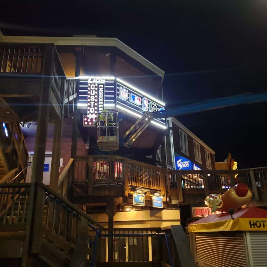 Multi-level retail building featuring Lids storefront signage and nighttime architectural branding by Gable.