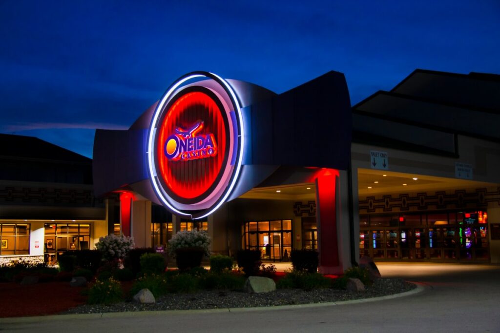 Oneida Casino entrance canopy with glowing circular logo sign and branded exterior graphics by Gable.