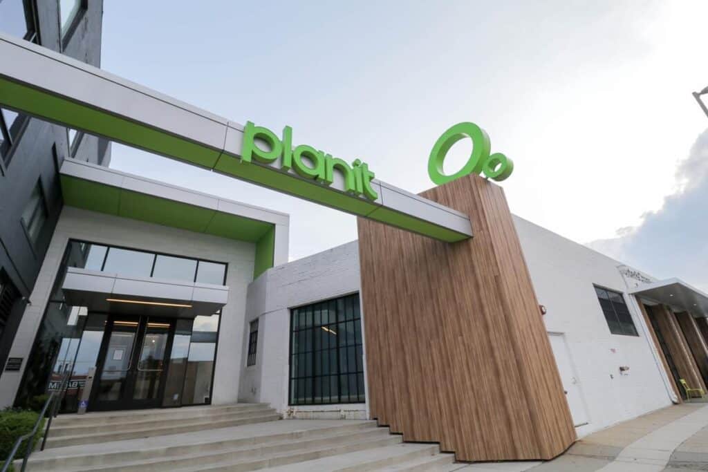 Plant O2 storefront entrance with branded architectural signage and exterior visual communications by Gable.