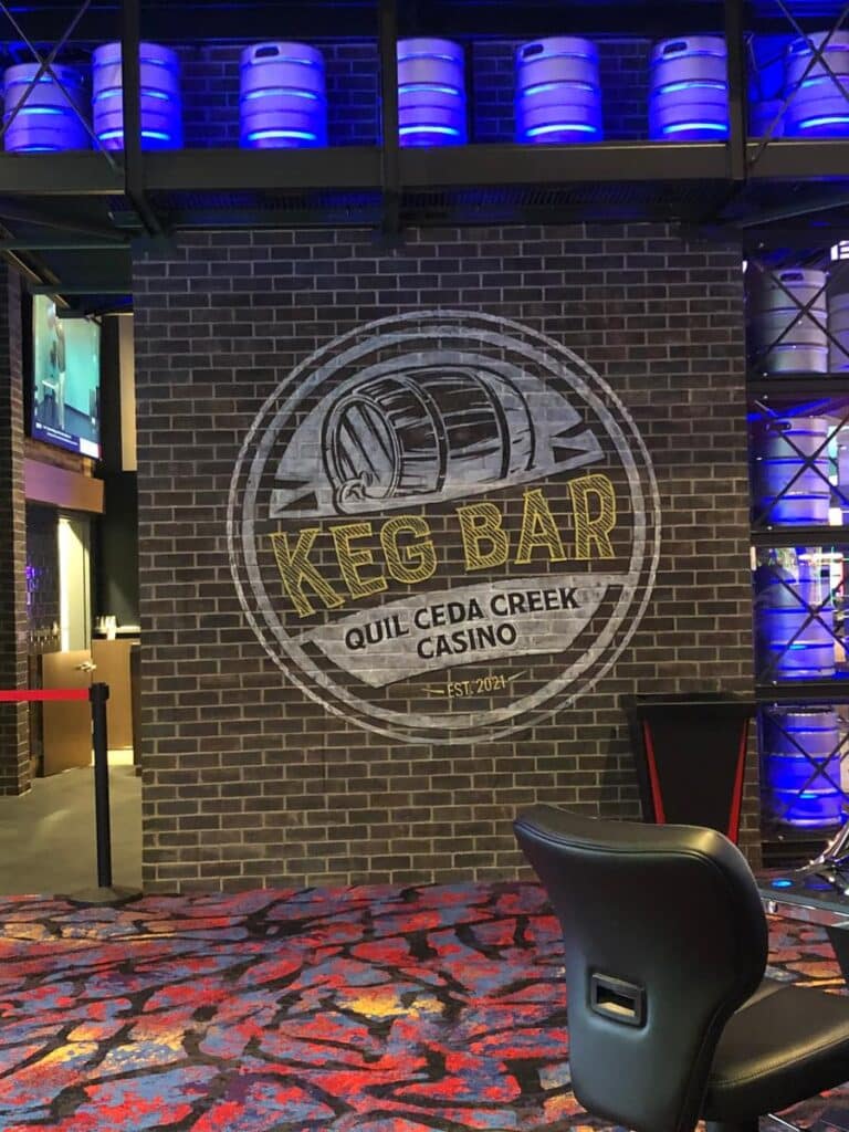 Keg Bar interior wall logo sign at Quil Ceda Creek Casino with decorative barrel display lighting.
