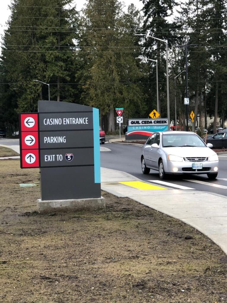 Quil Ceda Creek Casino roadside wayfinding sign directing guests to casino entrance, parking, and exit.