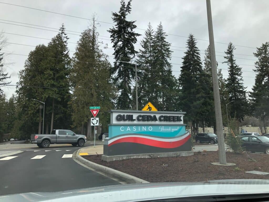 Quil Ceda Creek Casino monument sign at the roadway entrance with landscaped branding feature.