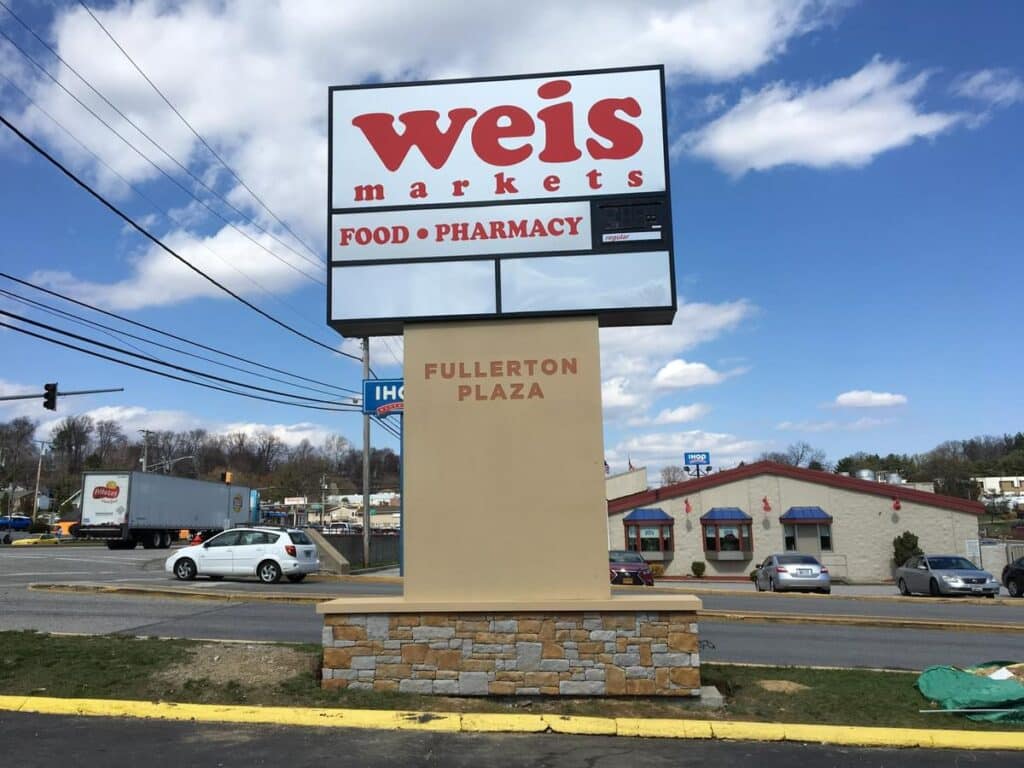 Weis Food Pharmacy pylon sign along a commercial roadway with branded retail visual communications by Gable.