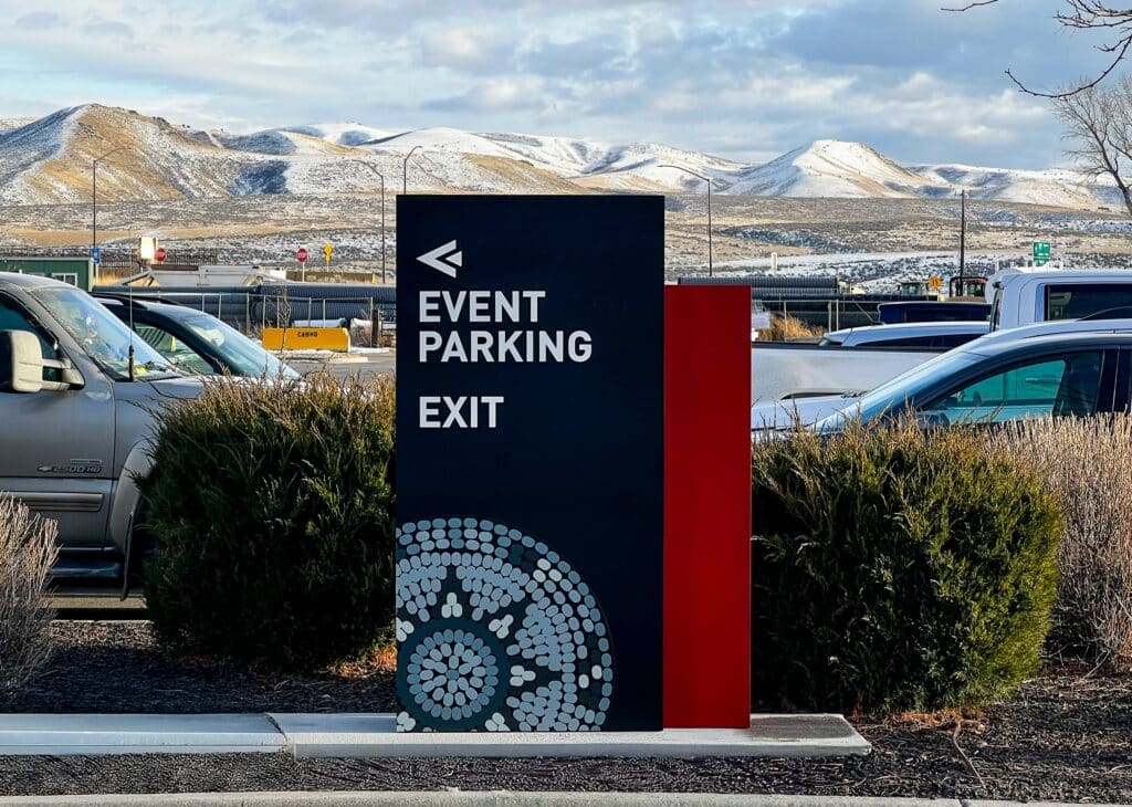 Event parking exit wayfinding sign at Shoshone-Bannock Casino with mountain backdrop.