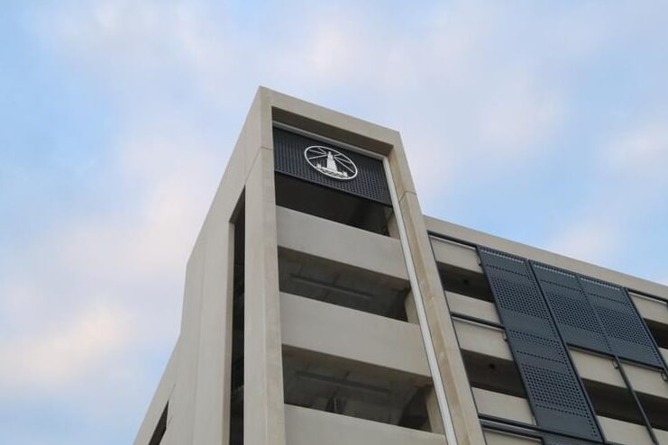 Alexandria parking structure with upper-level logo signage and architectural wayfinding by Gable.