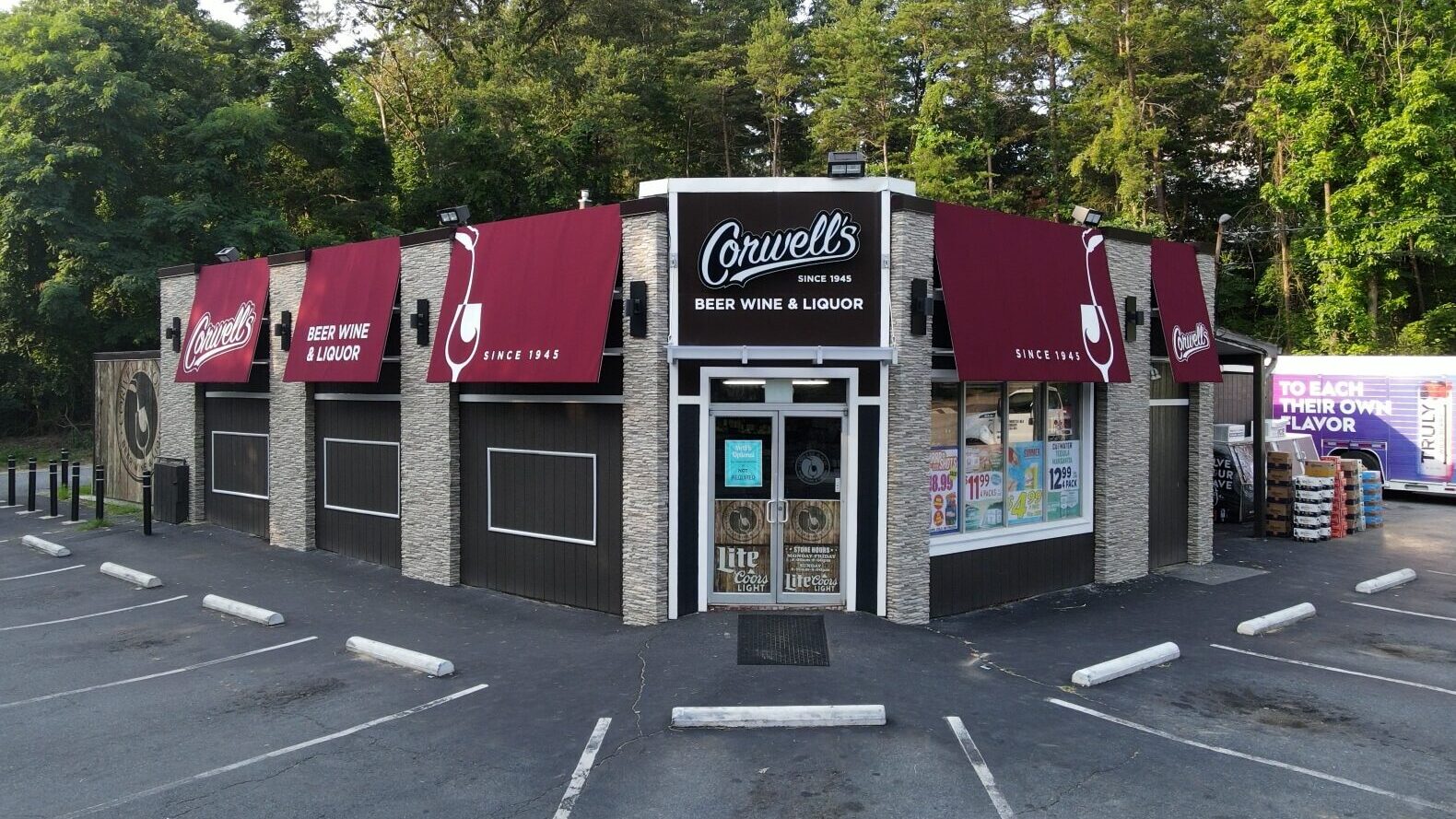 Corwell’s Beer Wine & Liquor exterior with branded awnings and custom storefront signage by Gable.