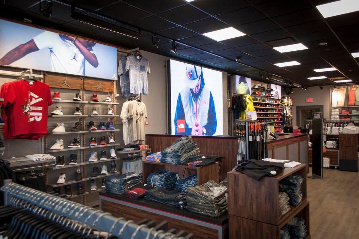 DTLR retail store interior with large digital display walls, branded merchandise presentation, and visual communications by Gable.