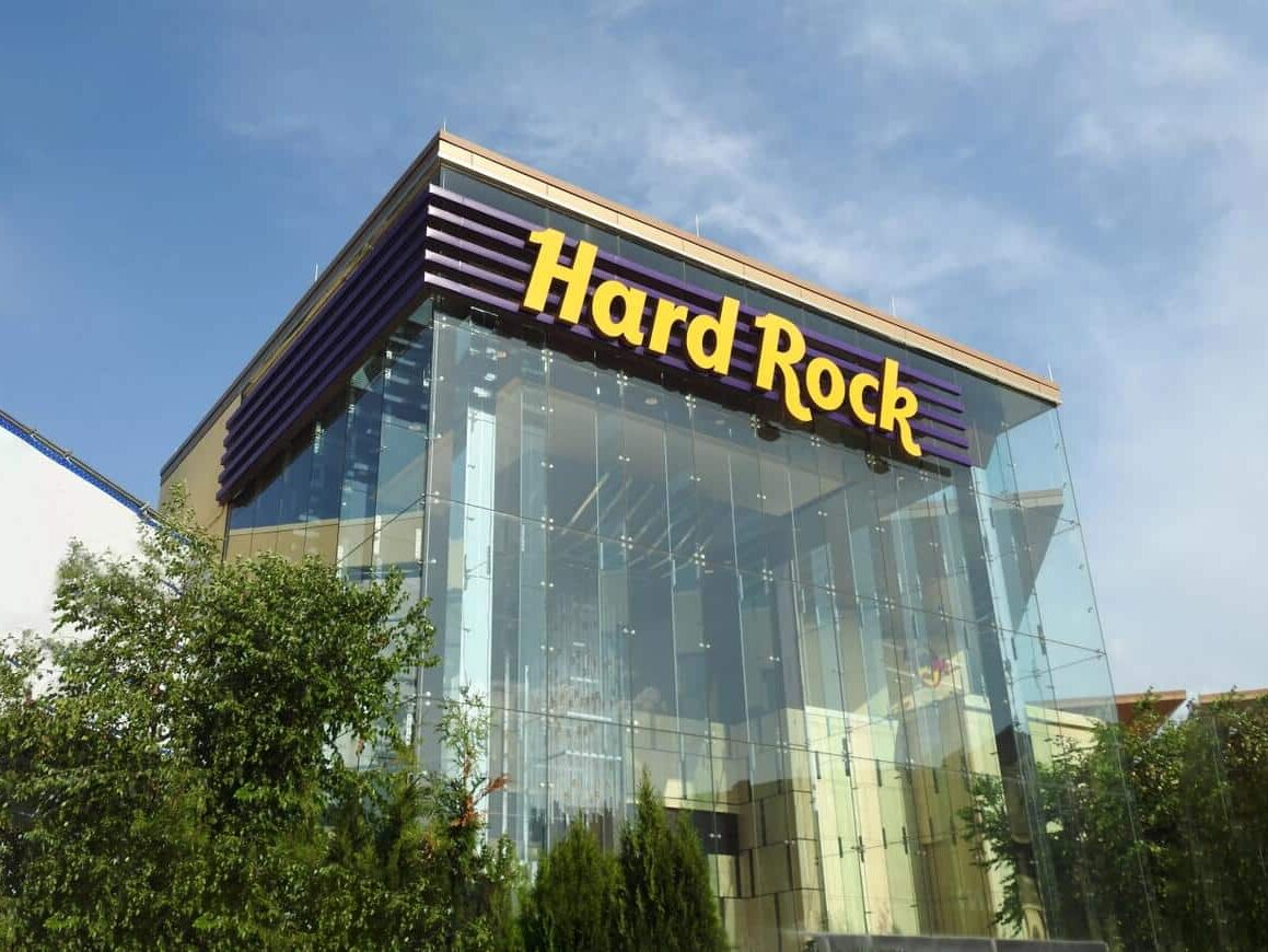 Hard Rock glass entry tower with illuminated exterior branding and architectural signage by Gable.