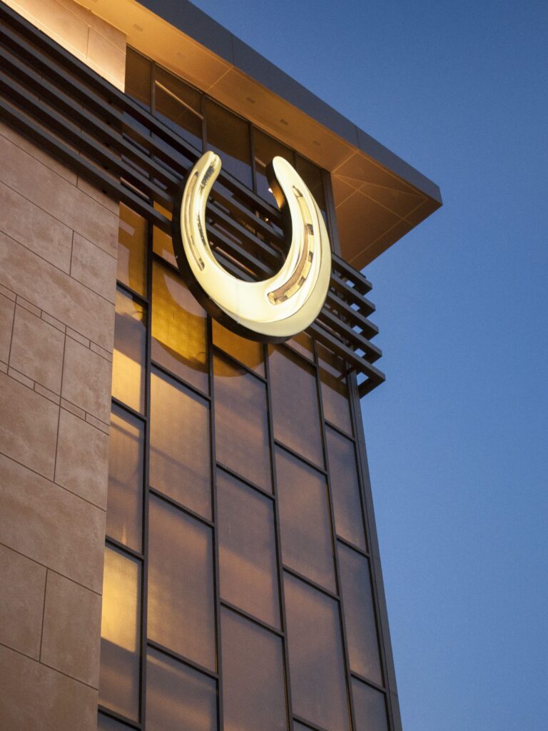 Close-up of Horseshoe Casino illuminated logo feature integrated into the building facade by Gable.