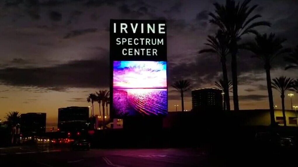 Illuminated Irvine Spectrum Center digital billboard at night showcasing experiential retail signage by Gable.