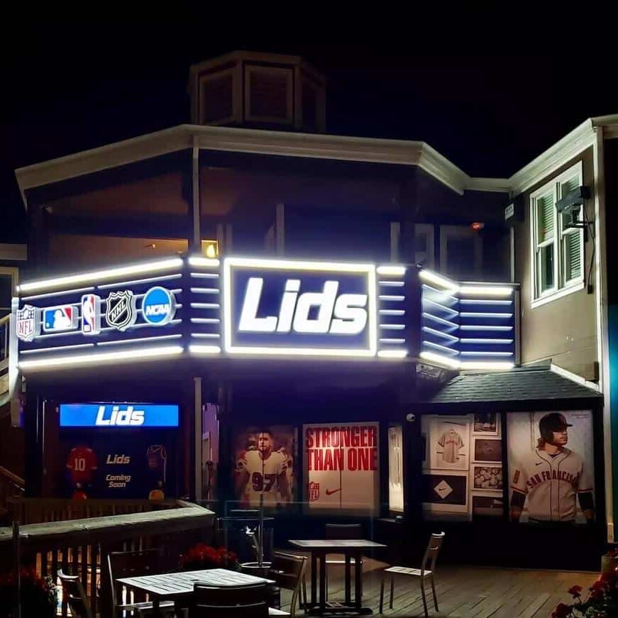 Close-up of Lids illuminated channel letter sign on a retail facade, designed by Gable.