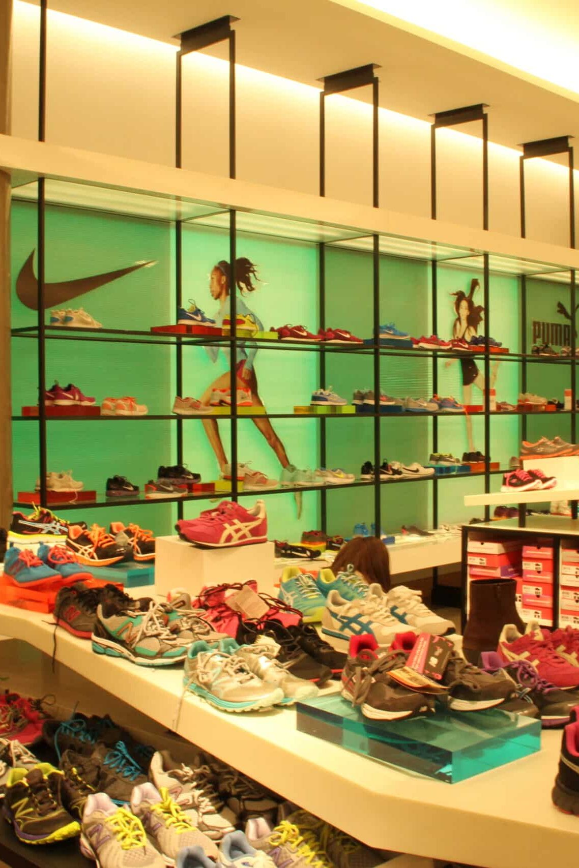 Luxury footwear retail environment with illuminated shelving and custom merchandising graphics by Gable.