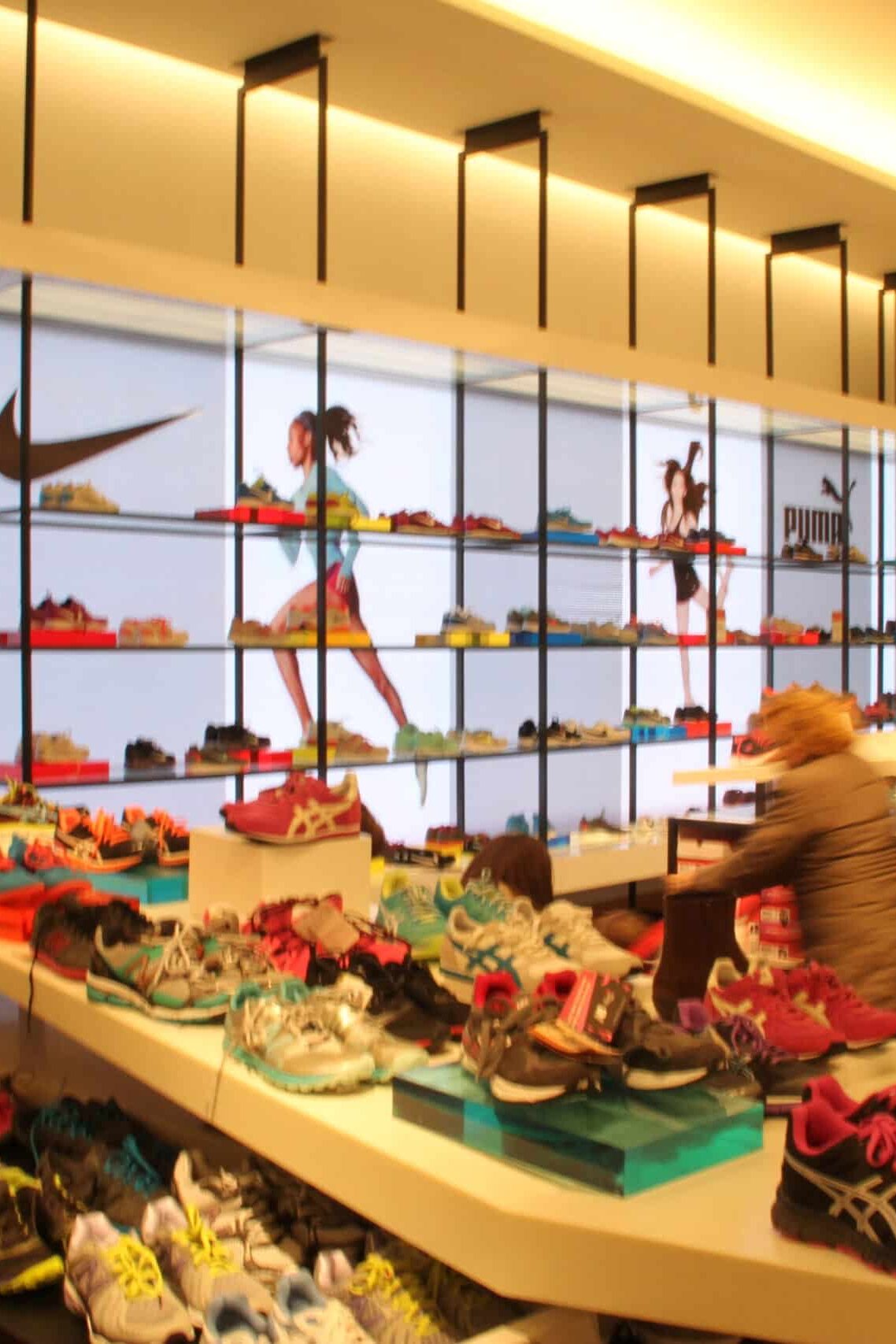 Designer shoe department with custom shelving, branded retail displays, and environmental graphics by Gable.