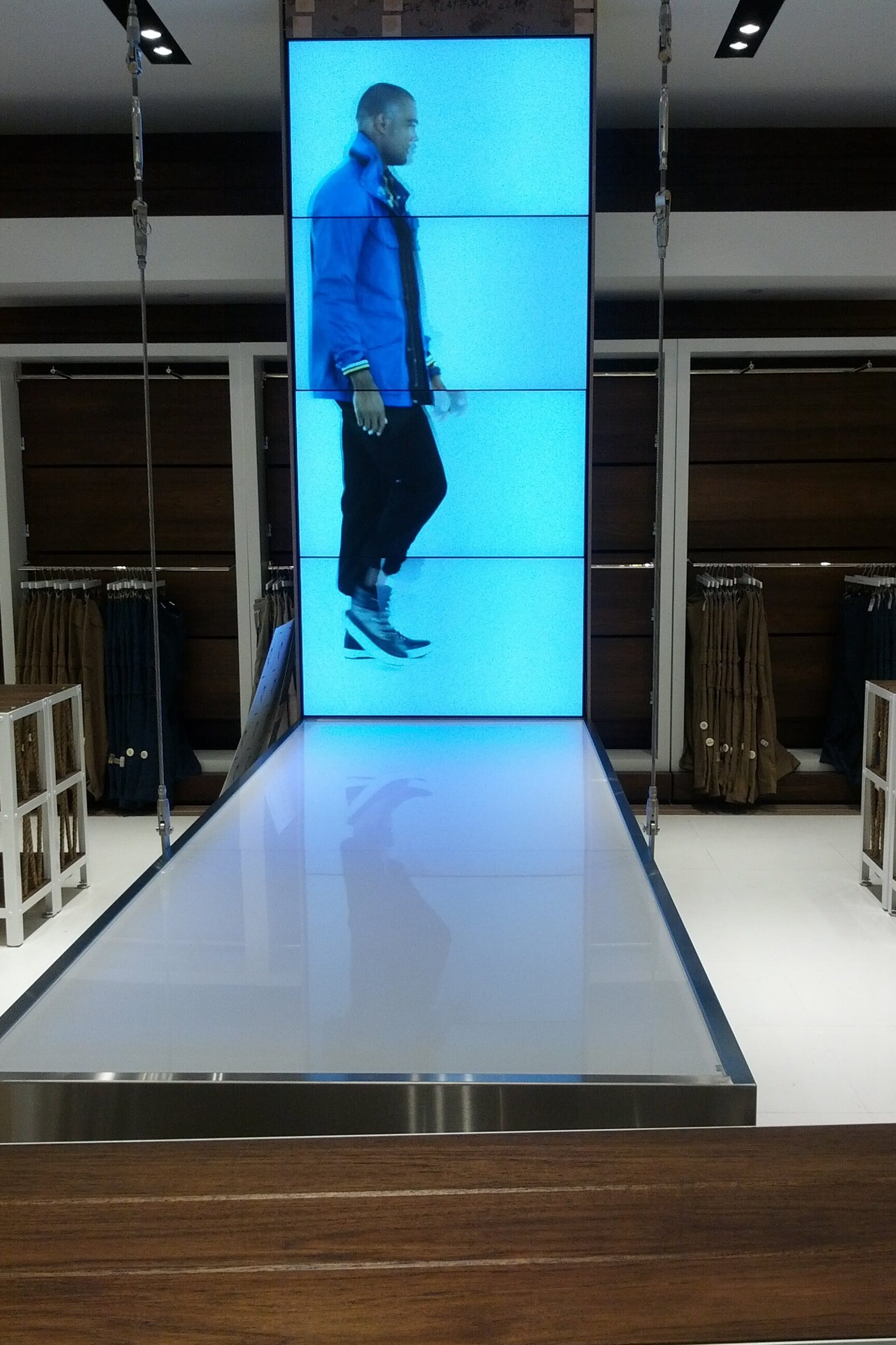 Freestanding digital fashion display tower with large-format media content and retail branding by Gable.
