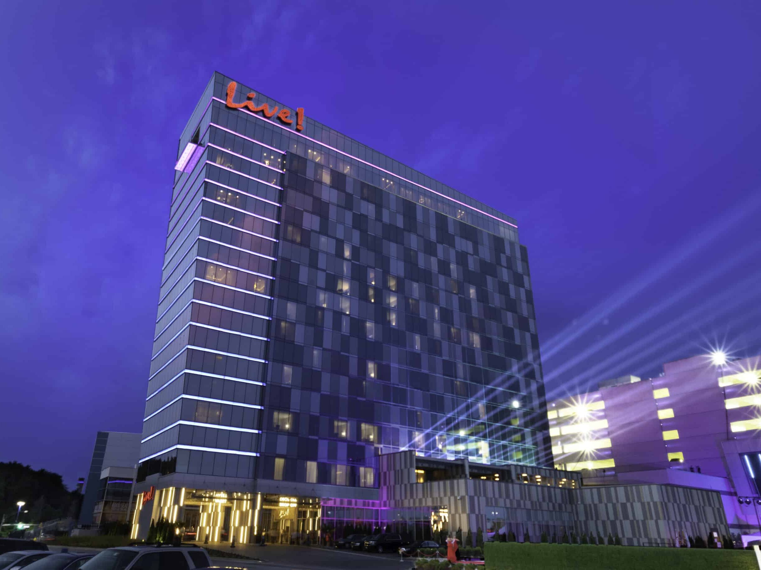 Live! Casino hotel tower at night with illuminated exterior branding and architectural signage by Gable.