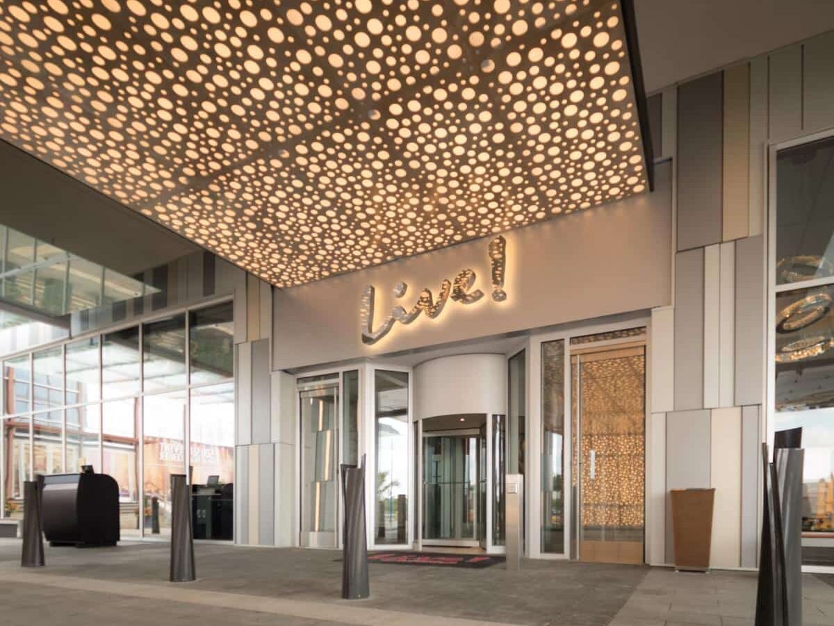 Live! hotel entry with illuminated script signage and upscale hospitality branding by Gable.