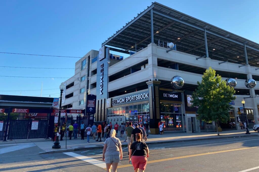 Exterior brand identity signs, digital displays, and architectural elements at the BetMGM Sportsbook at Nationals Park