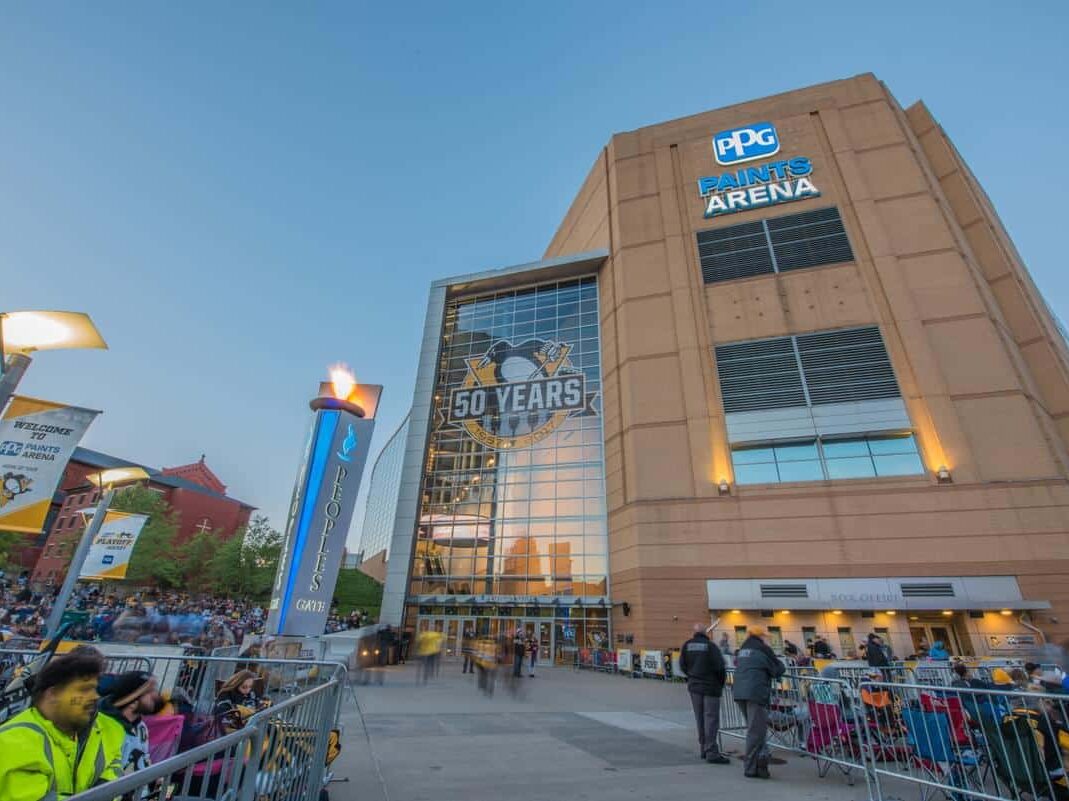 Arena exterior facade featuring illuminated building signage and architectural branding by Gable.