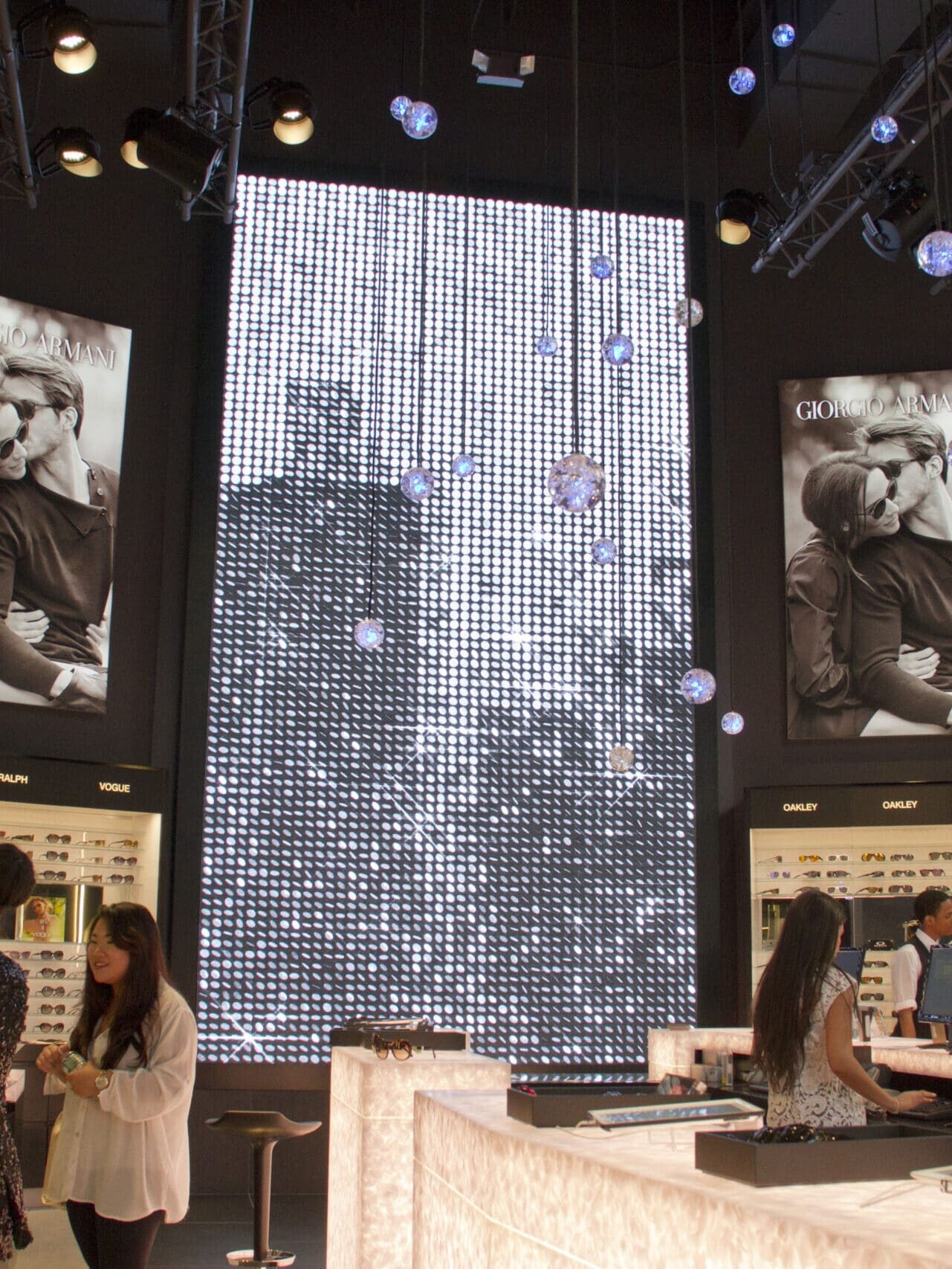 Immersive digital media wall in an eyewear retail environment with custom visual communications by Gable.