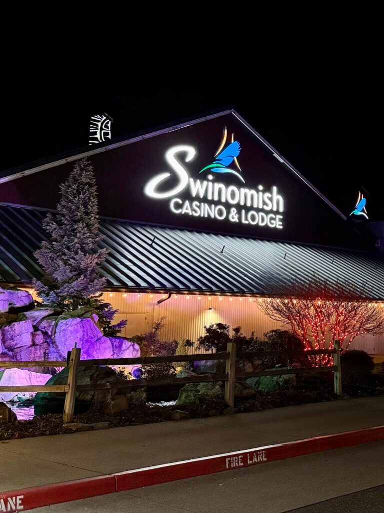 Swinomish Casino & Lodge exterior at night with illuminated architectural signage and visual communications by Gable.
