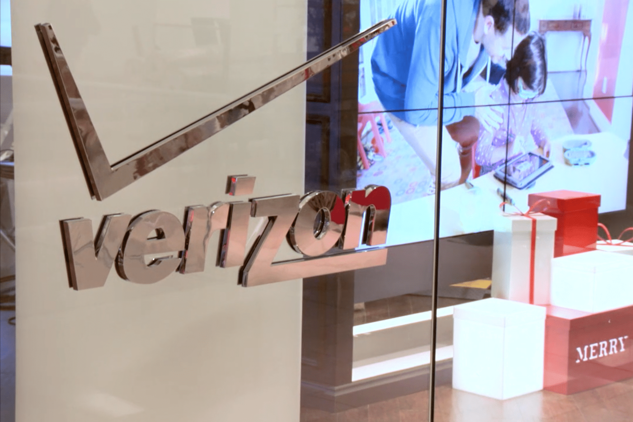 Verizon glass logo signage inside a retail environment with branded architectural graphics by Gable.